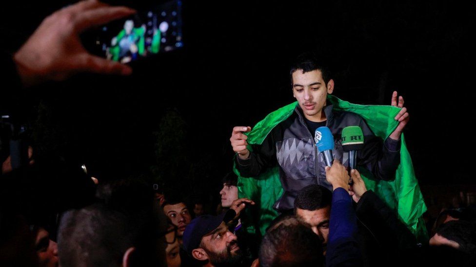 A released Palestinian detainee speaks to media as he leaves the Israeli military prison, Ofer