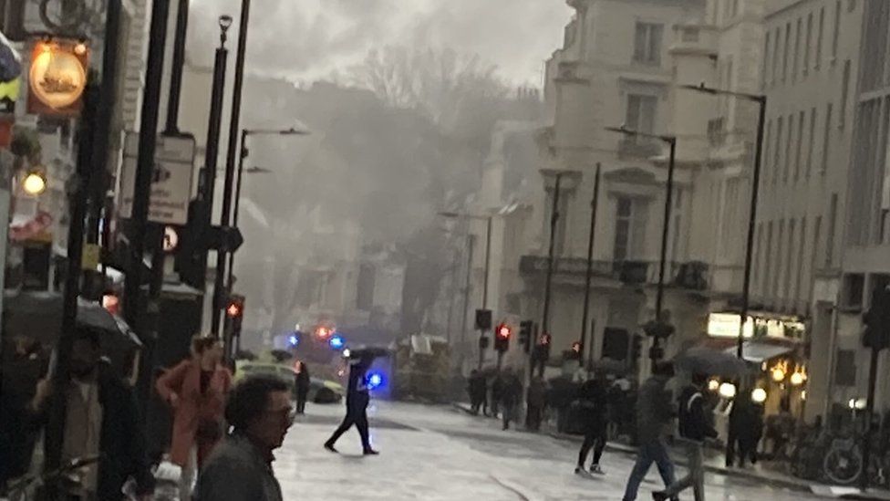 Smoke can be seen rising in the street