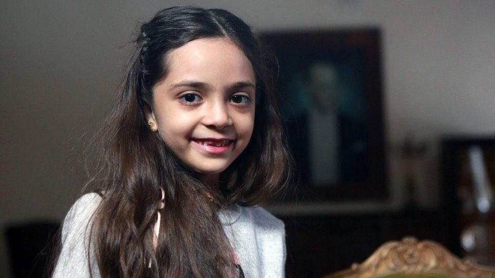 Bana Alabed, 7, is pictured smiling in a professional news shot from the safety of Turkey in December