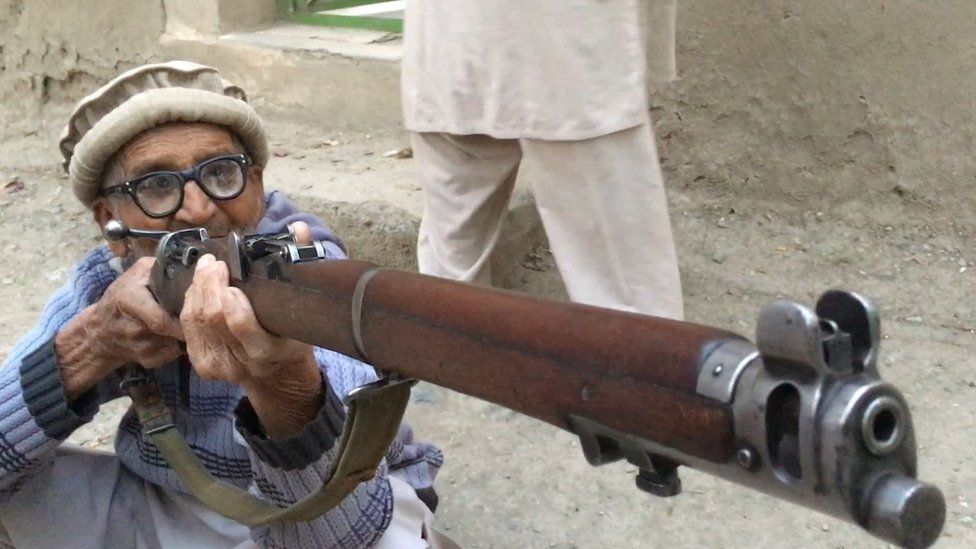 Hussain Gul holds the rifle he used in the battle for Pandu ridge