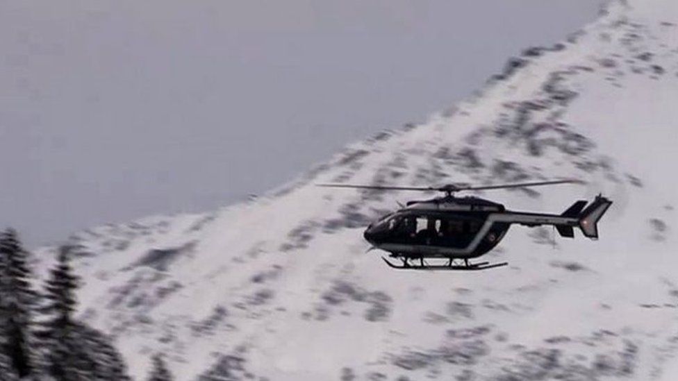 A helicopter flies over the area where an avalanche killed five French Foreign Legionnaires. Photo: 18 January 2016