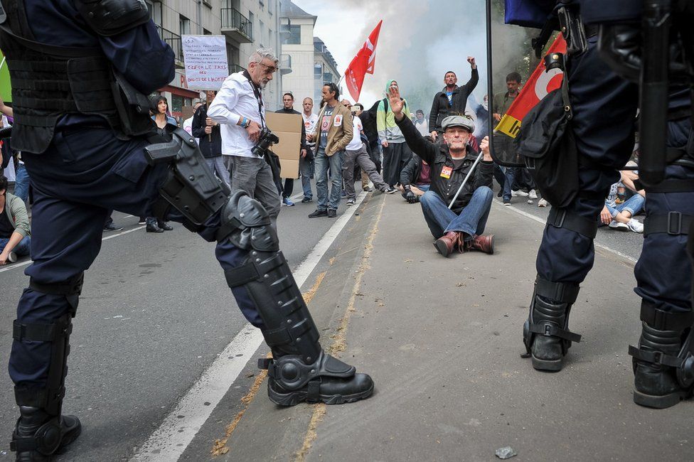 Riot police face protesters in the French city of Tours, 26 May