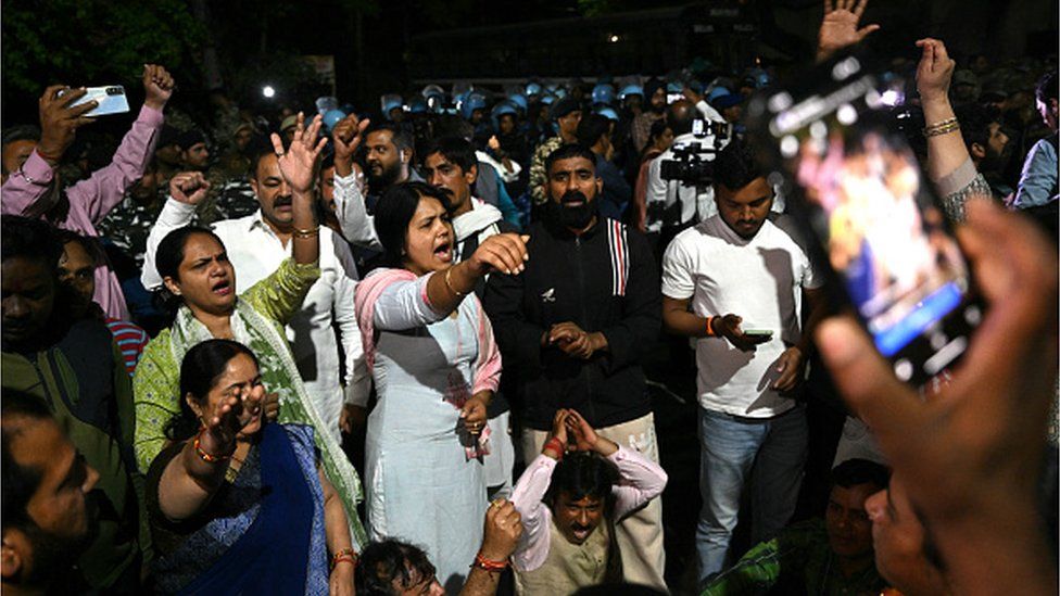 Supporters of the Aam Aadmi Party shout slogans in front of the home of Aam Aadmi Party chief and Delhi Chief Minister Arvind Kejriwal after he was arrested in a corruption case by the Enforcement Directorate in New Delhi on March 21, 2024.
