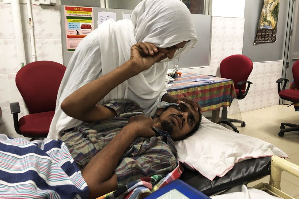 Mohammad Razak Taslim in hospital, with his wife