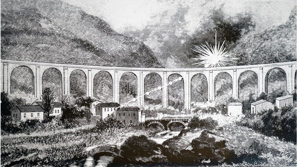 A black and white drawing of a ball of light flashing in the sky above a viaduct.