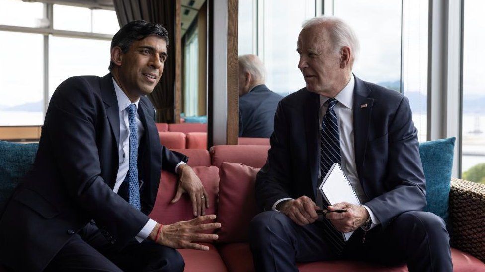Prime Minister Rishi Sunak talks with US President Joe Biden before a session on the first day of the G7 Leaders Summit