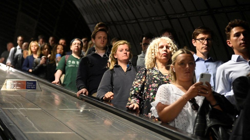 Passengers take an escalator, ahead of a planned national strike by rail workers, at Waterloo Station, in London, Britain, 20 June 2022.