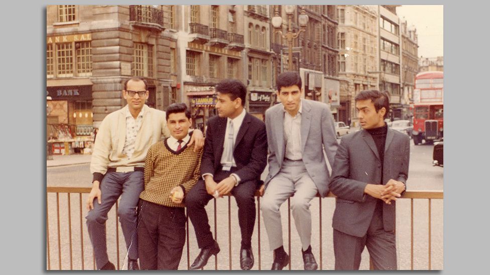 Praful's YMCA friends sitting on the railings at Piccadilly Circus
