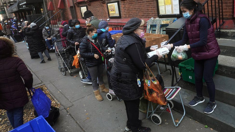 People wait in line at the St. Clements Food Pantry for food during the coronavirus disease (COVID-19) pandemic in the Manhattan borough of New York City, New York, U.S., December 11, 2020.
