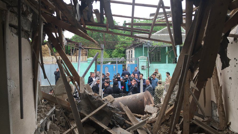 Journalists are shown buildings that Azerbaijan says were destroyed by Armenian shelling