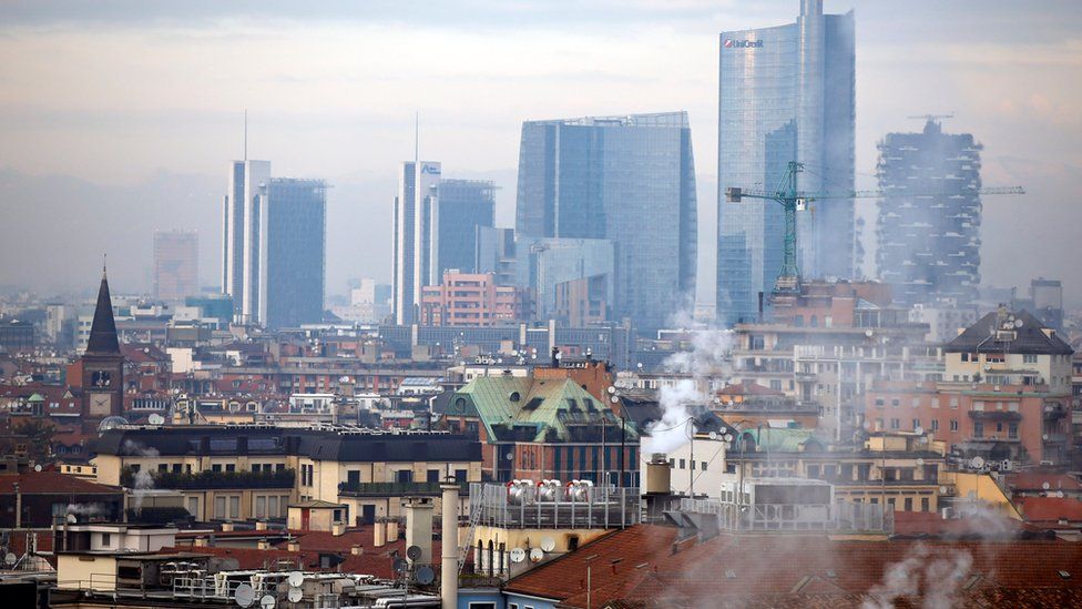 Smoke billows from chimneys in Milan, Italy, Tuesday, Dec. 22, 2015.