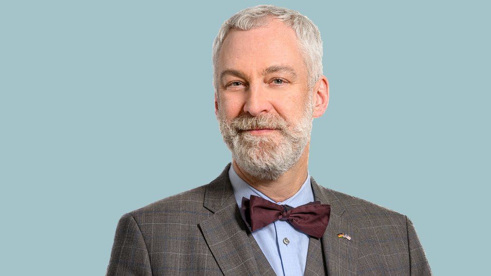 Man in bowtie looking directly at camera