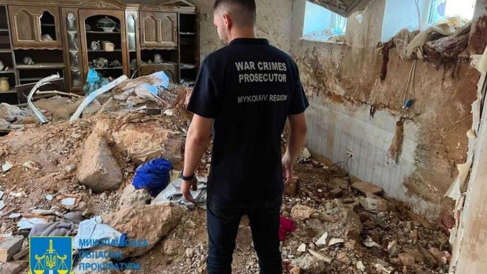 A Ukrainian investigator works inside one of the damaged houses in Mykolaiv, southern Ukraine. Photo: 31 July 2022