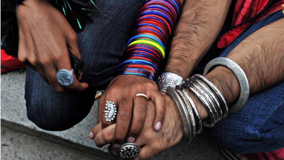 Indian gay men hold hands as they participate in a gay pride march in Bangalore on June 28, 2009.