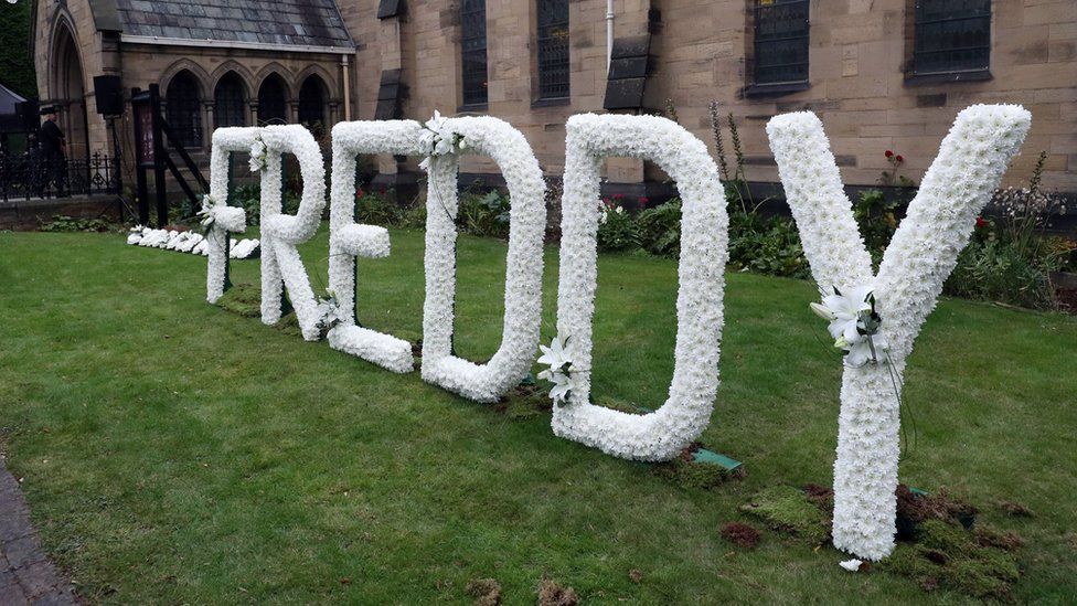 A floral tribute reading "Freddy"