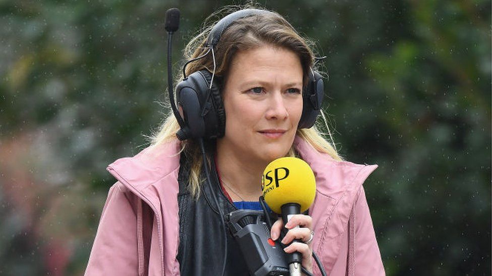 Jennie Gow with microphone in the rain