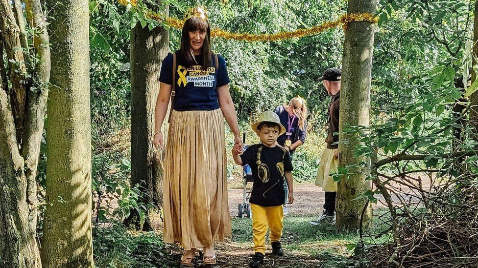 Lisa Ratcliffe and George walking through a forest