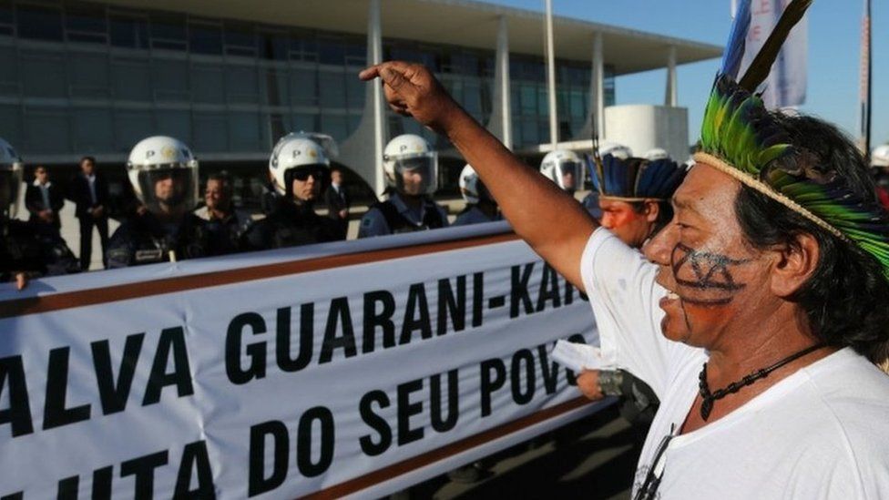 a Guarani Kaiowa Indian leader denounces the murder of indigenous leader Simao Vilhalva during a protest in front of the Planalto Presidential Palace, in Brasilia, Brazil, Tuesday, Sep. 1, 2015.