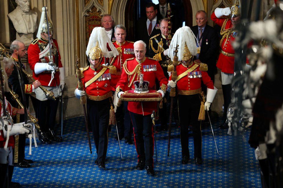 The Imperial State Crown is carried through the Norman Porch ahead of the State Opening of Parliament in the House of Lords on November 7, 2023 in London, England.