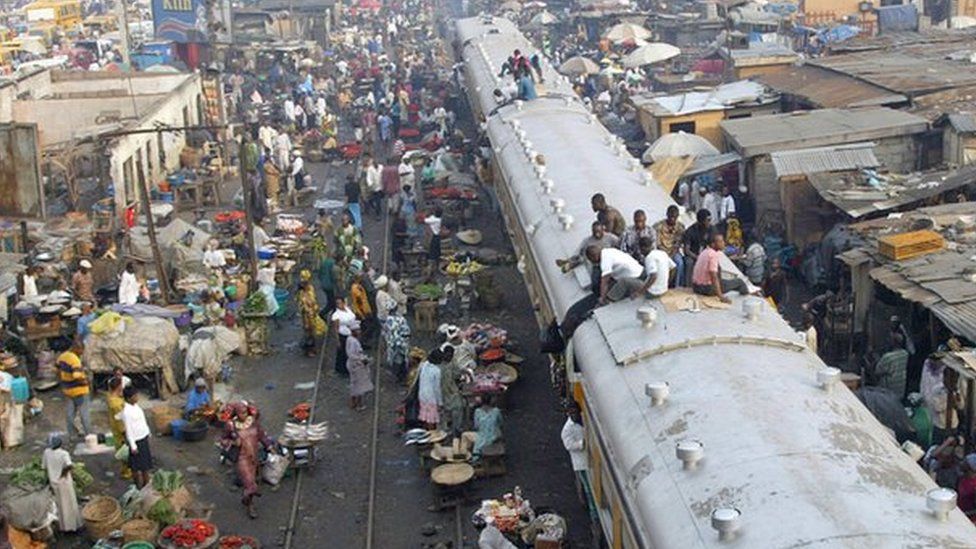 Commuters sitting on top of a train in Lagos, Nigeria.