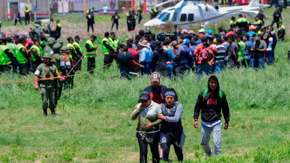 People leave the scene of the explosion in Tultepec Mexico July 2018