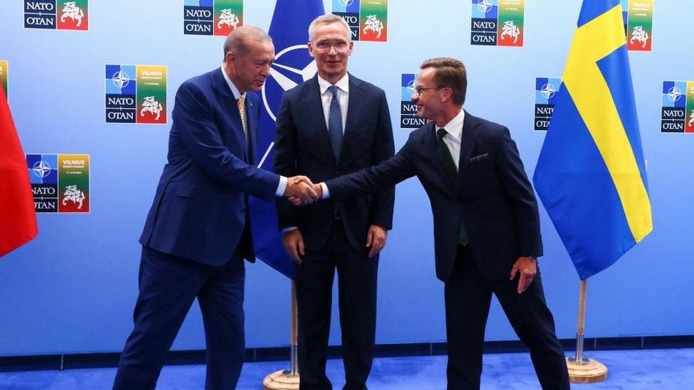 Turkish President Tayyip Erdogan and Swedish Prime Minister Ulf Kristersson shake hands next to NATO Secretary-General Jens Stoltenberg prior to their meeting, on the eve of a NATO summit, in Vilnius, Lithuania July 10, 2023