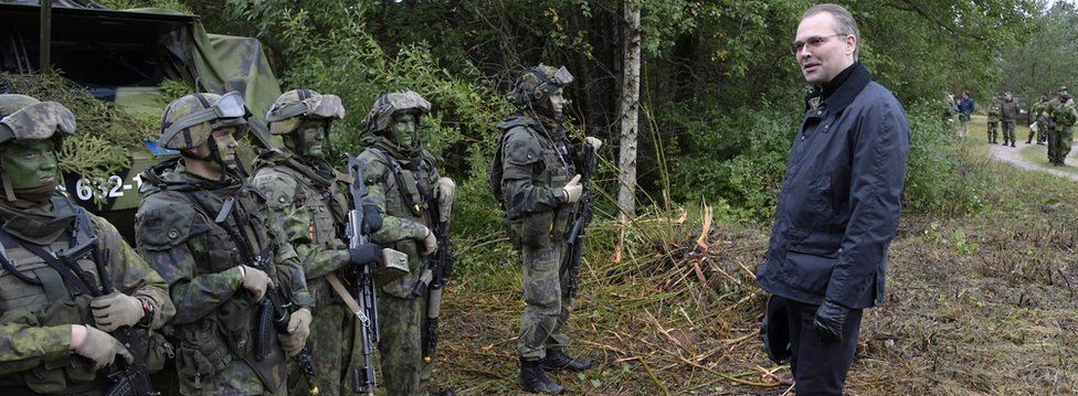 Finland's Defence Minister Jussi Niinisto inspects Finnish troops during a co-operation of the Finnish and Swedish troops on the Swedish island of Gotland September 19, 2017