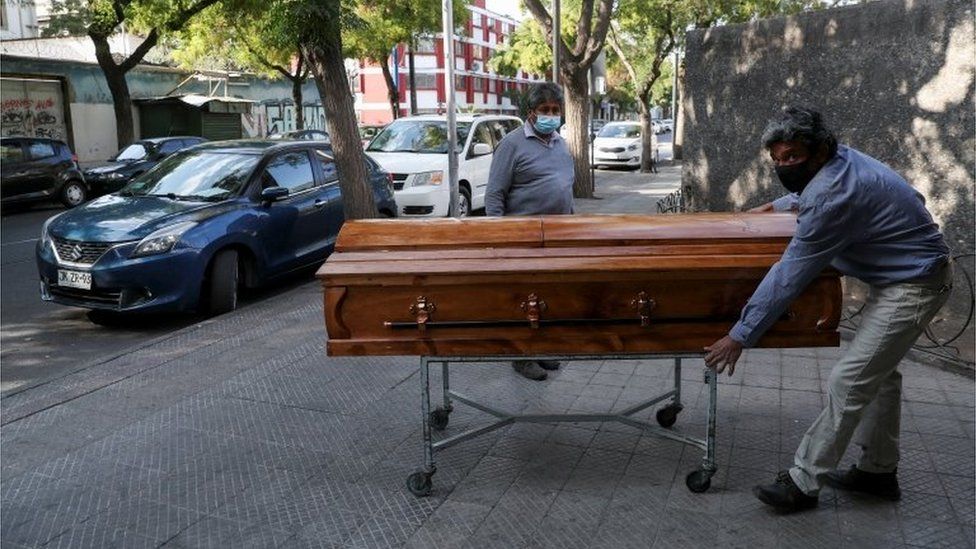 Работники похоронного бюро переносят гроб у морга на территории больницы во время пандемии коронавирусной болезни (COVID-19) в Сантьяго, Чили, 8 апреля 2021 г.