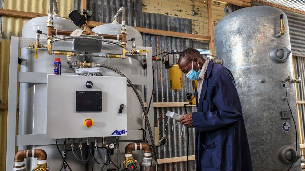 A technician installs the final phase of a domestic oxygen plant at Metropolitan Hospital in Kenya's capital Nairobi on May 2021