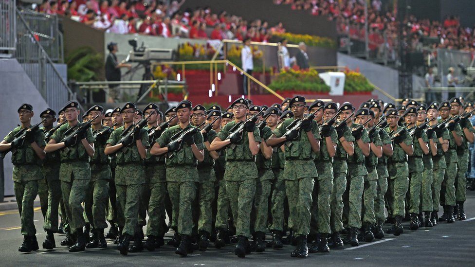 Singapore Armed Forces contingent takes part in a parade during Singapore's 50th National day anniversary celebration