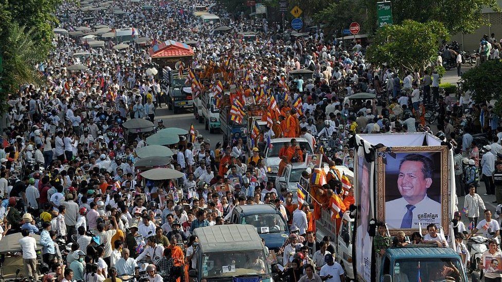Thousands of people take part in a funeral procession in Phnom Penh on July 24, 2016 for Kem Ley