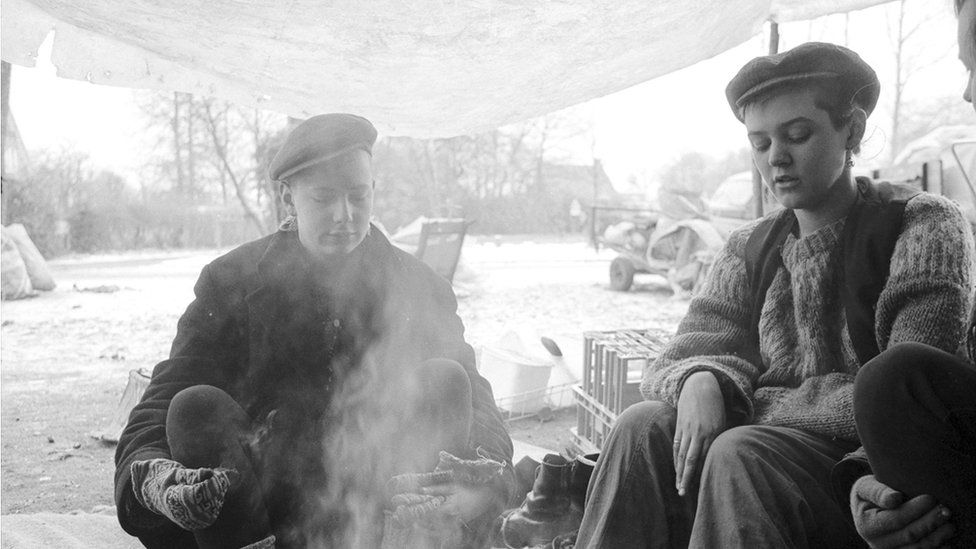 Women sitting around a camp fire