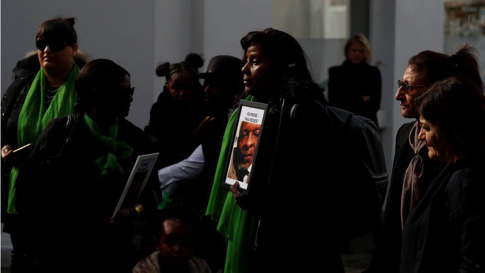 Bernadette Bernard holding up a picture of her brother