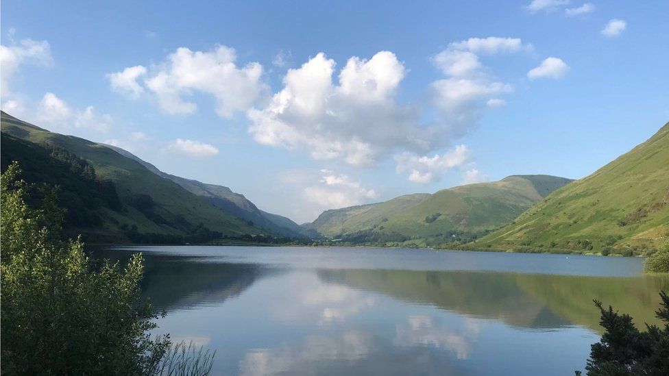 A mountainous vista reflected in Tal-y-Llyn lake.