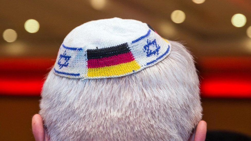 A man wearing a Jewish kippa skullcap with the flags of Germany and Israel in this 2014 file photo