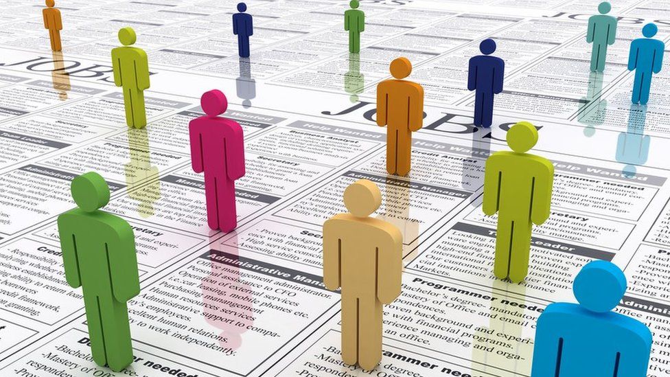 Colourful figures standing on newspaper job adverts