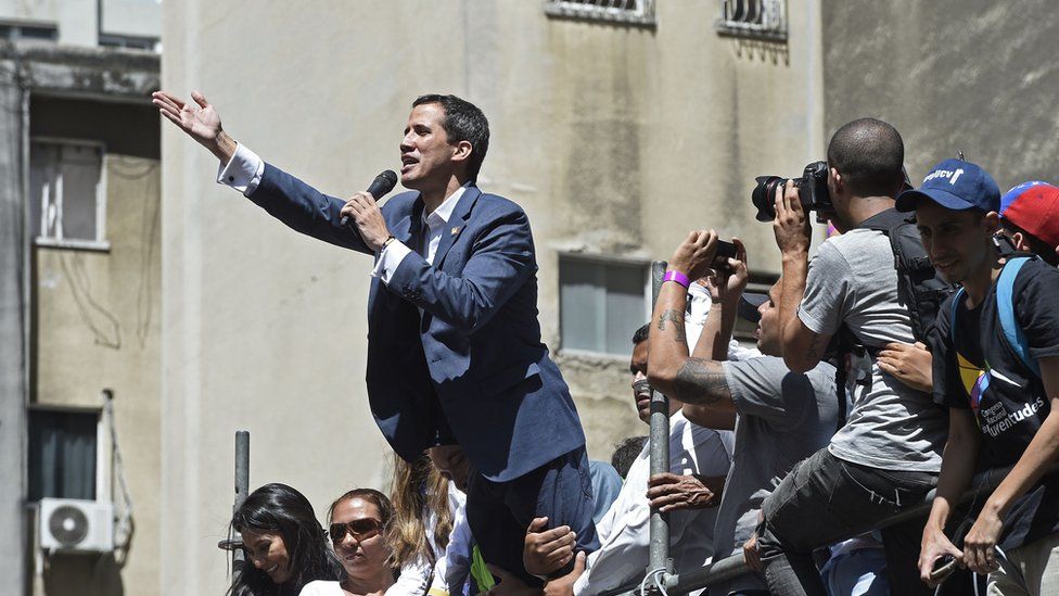 Venezuelan opposition leader and self declared acting president Juan Guaido speaks during a rally to press the military to let in US humanitarian aid, in eastern Caracas on February 12, 2019.