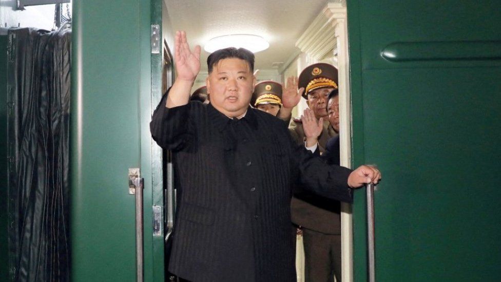 North Korean leader Kim Jong Un waves from a train as he leaves Pyongyang, North Korea