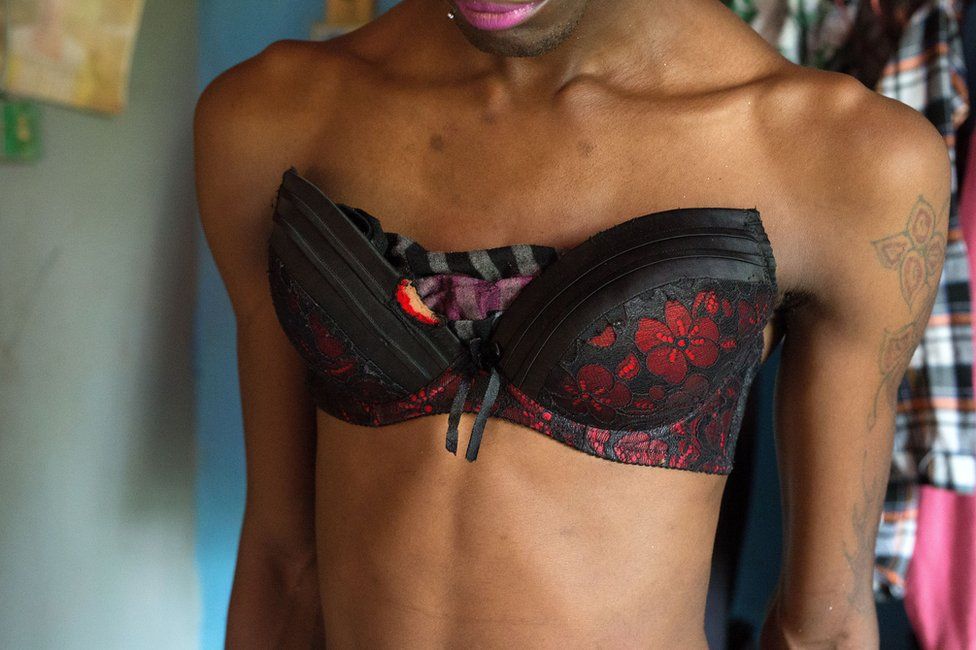 A person wearing a black and red bra