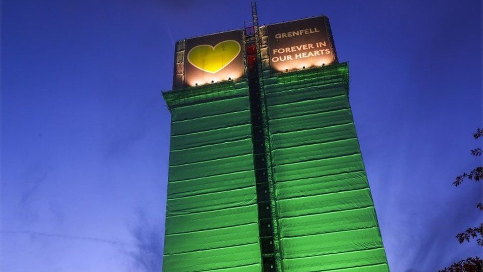 Grenfell Tower block lit up with green lights