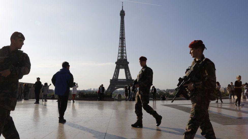 French soldiers of "Operation Sentinelle" patrol in front of the Eiffel Tower in Paris