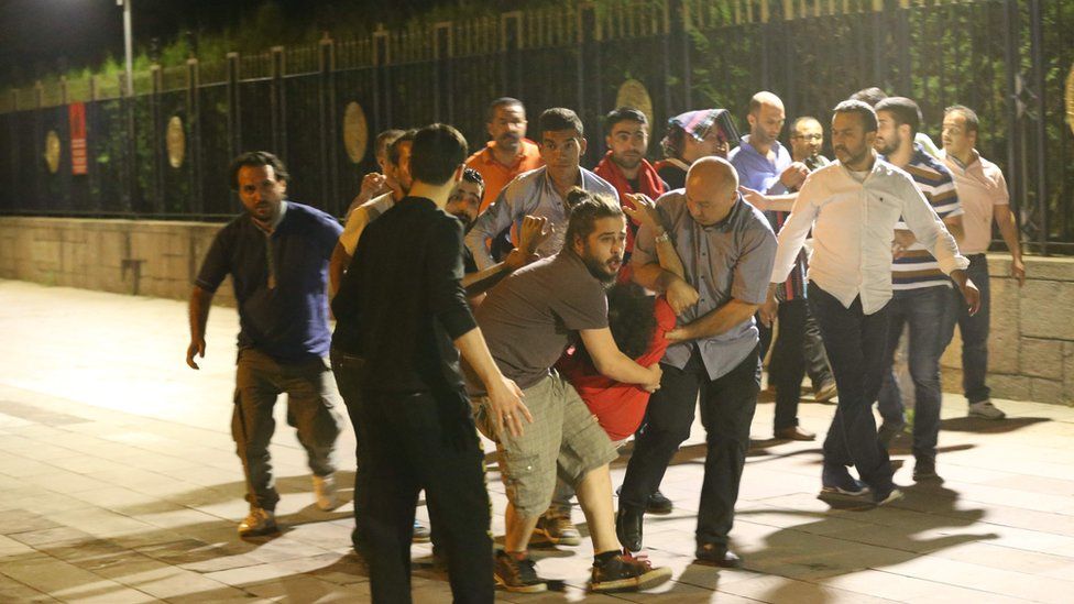 People carry an injured man in Ankara, Turkey, on 16 July 2016