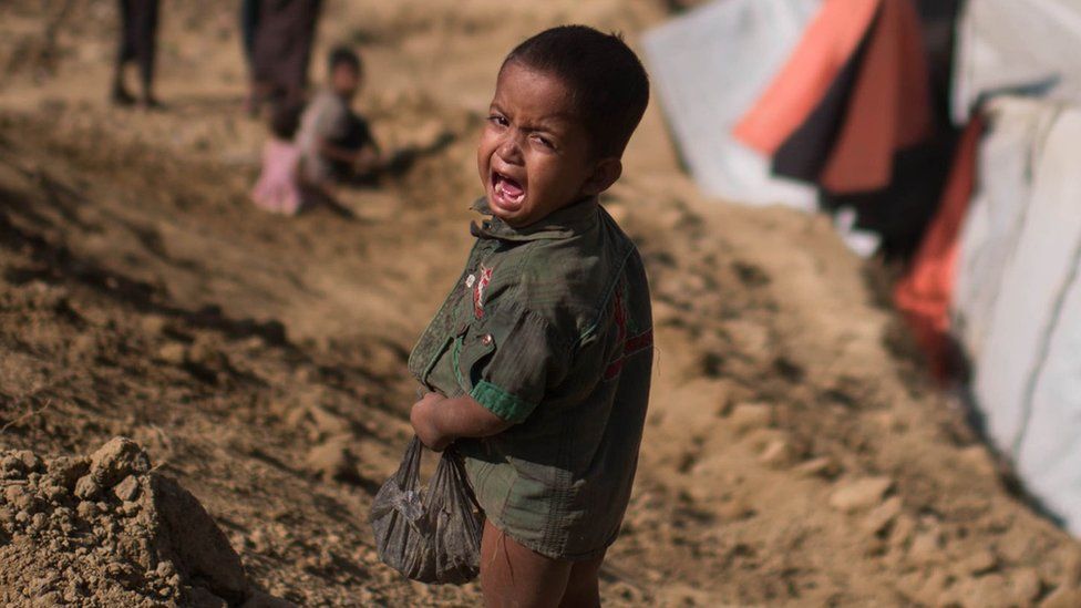 A Rohingya Muslim refugee child cries as he stands near the Thyangkhali refugee camp at Cox's Bazar, 29 November 2017
