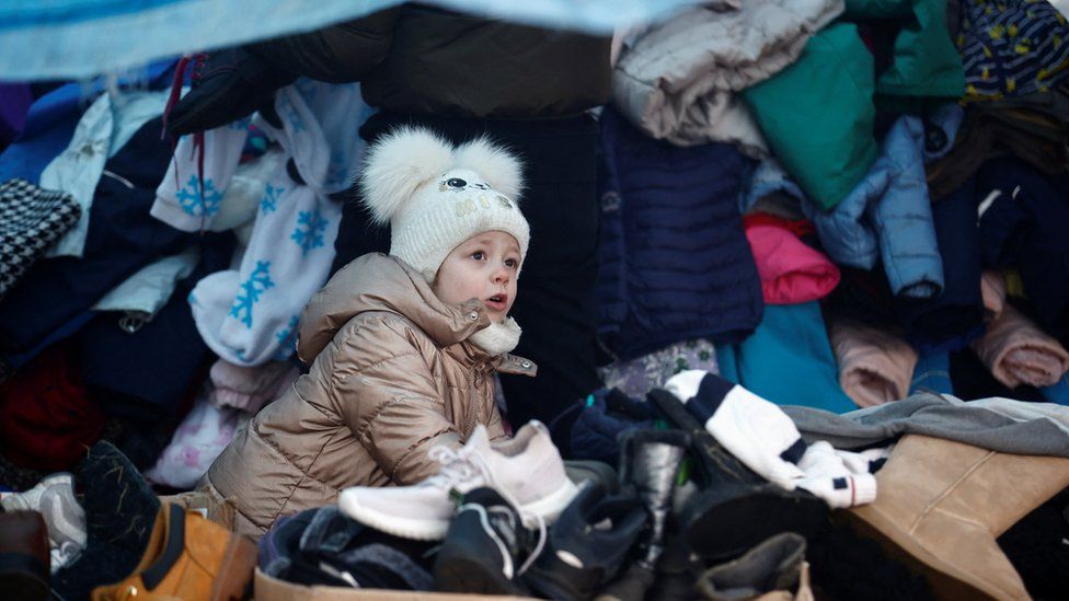 A child fleeing Russian invasion of Ukraine looks on at a temporary camp in Przemysl, Poland,
