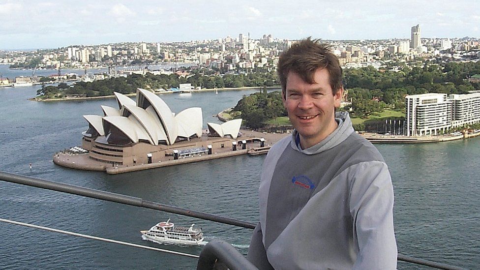 A man in front of Sydney Opera House