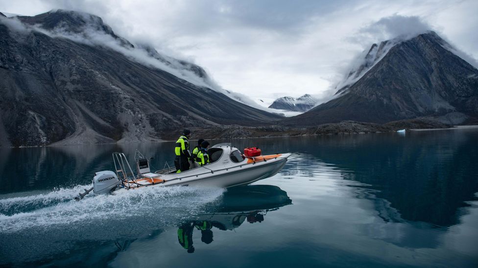 Scientists in a boat in an East Greenland fjord