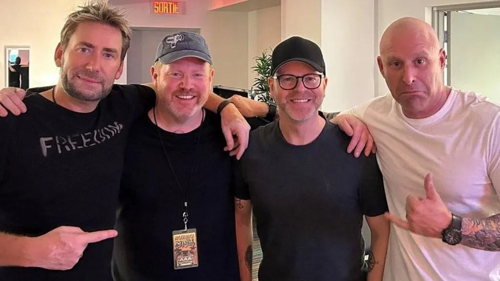 Members of Nickelback posed with broadcaster Ben Jones who produced the film