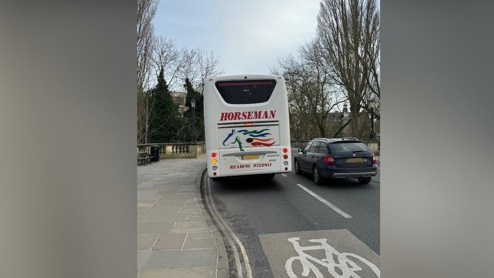 A coach stopped in a cycle lane