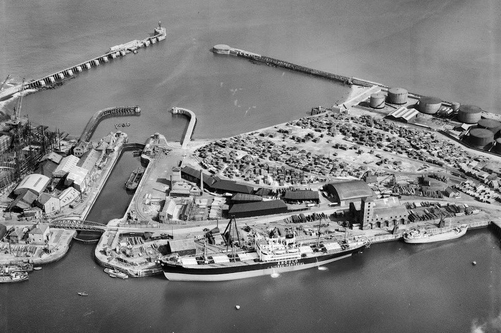 Aerial black and white view of a large ship next to Sunderland harbour