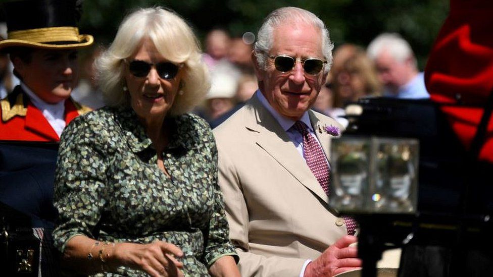 King Charles III and Queen Camilla arrive by horse drawn carriage for a visit to the Sandringham Flower Show